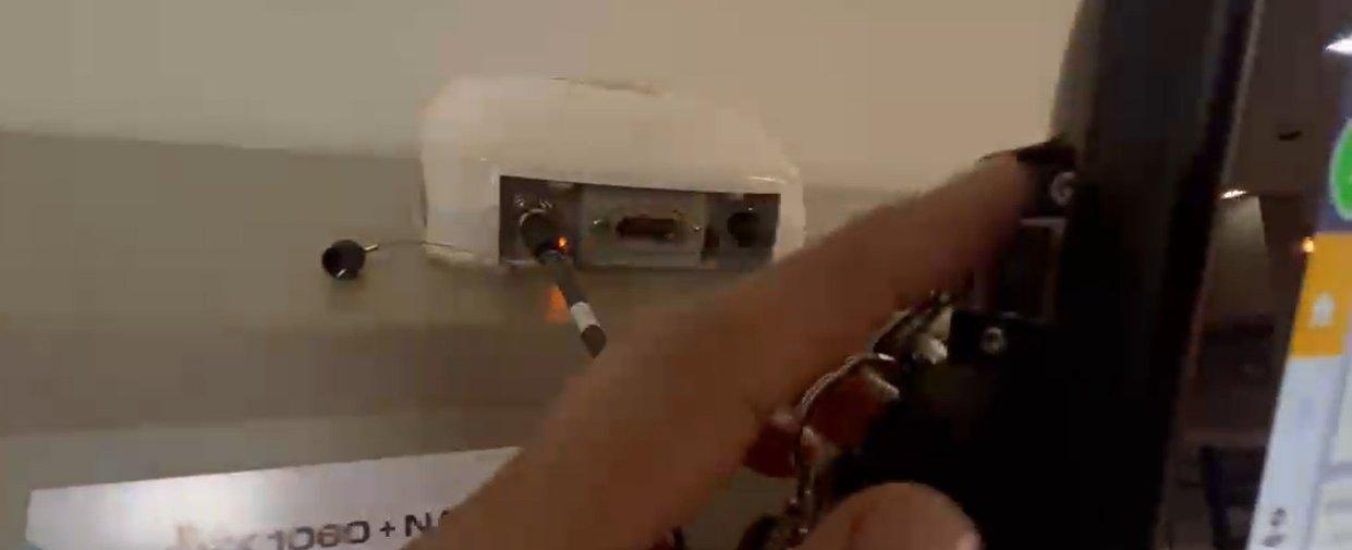 Inserting a USB drive into the port on the back of the Trimble GFX monitor